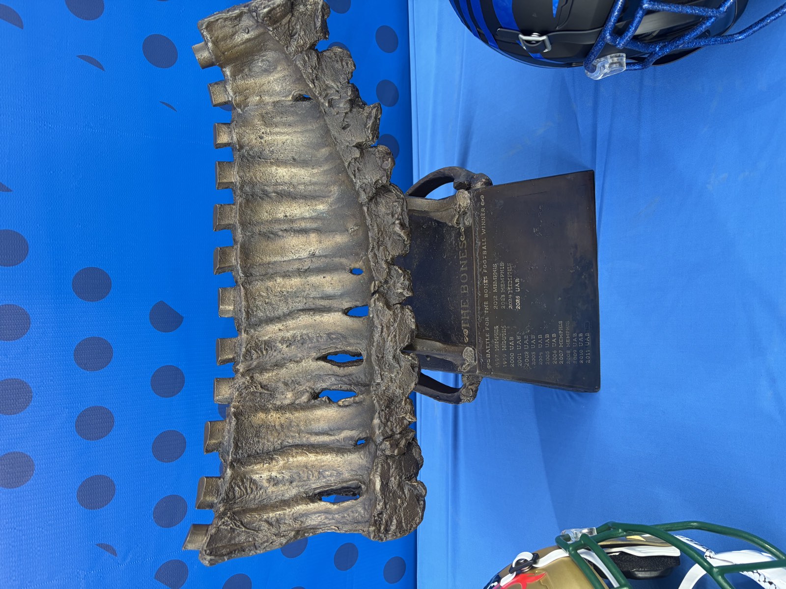 Close view of the Battle for the Bones trophy, a bronzed rack of ribs mounted on an engraved base